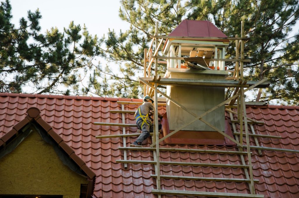 man repairing the house roof