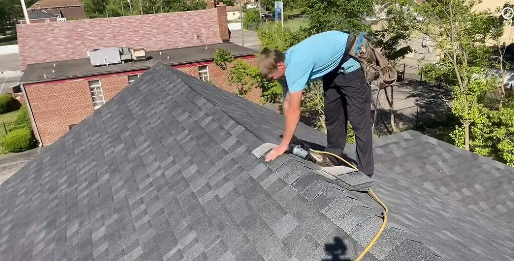 Roofer applying roofing cement on a rooftop during a same-day repair near Albuquerque