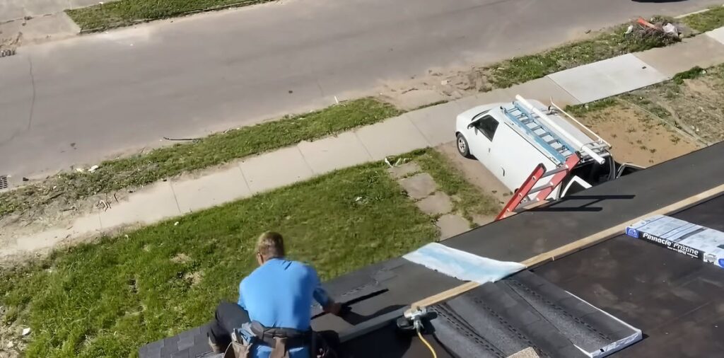 Albuquerque Roofing Guys van parked curbside while the crew works on a nearby roof