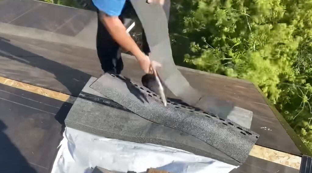 Local Albuquerque roofer sealing a shingle edge with roofing cement during a roof repair