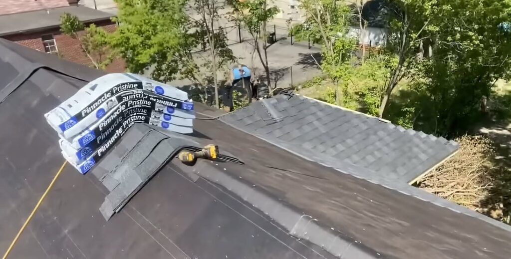 Albuquerque Roofing Guys crew member hand-nailing new asphalt shingles during a roof installation in Albuquerque, New Mexico